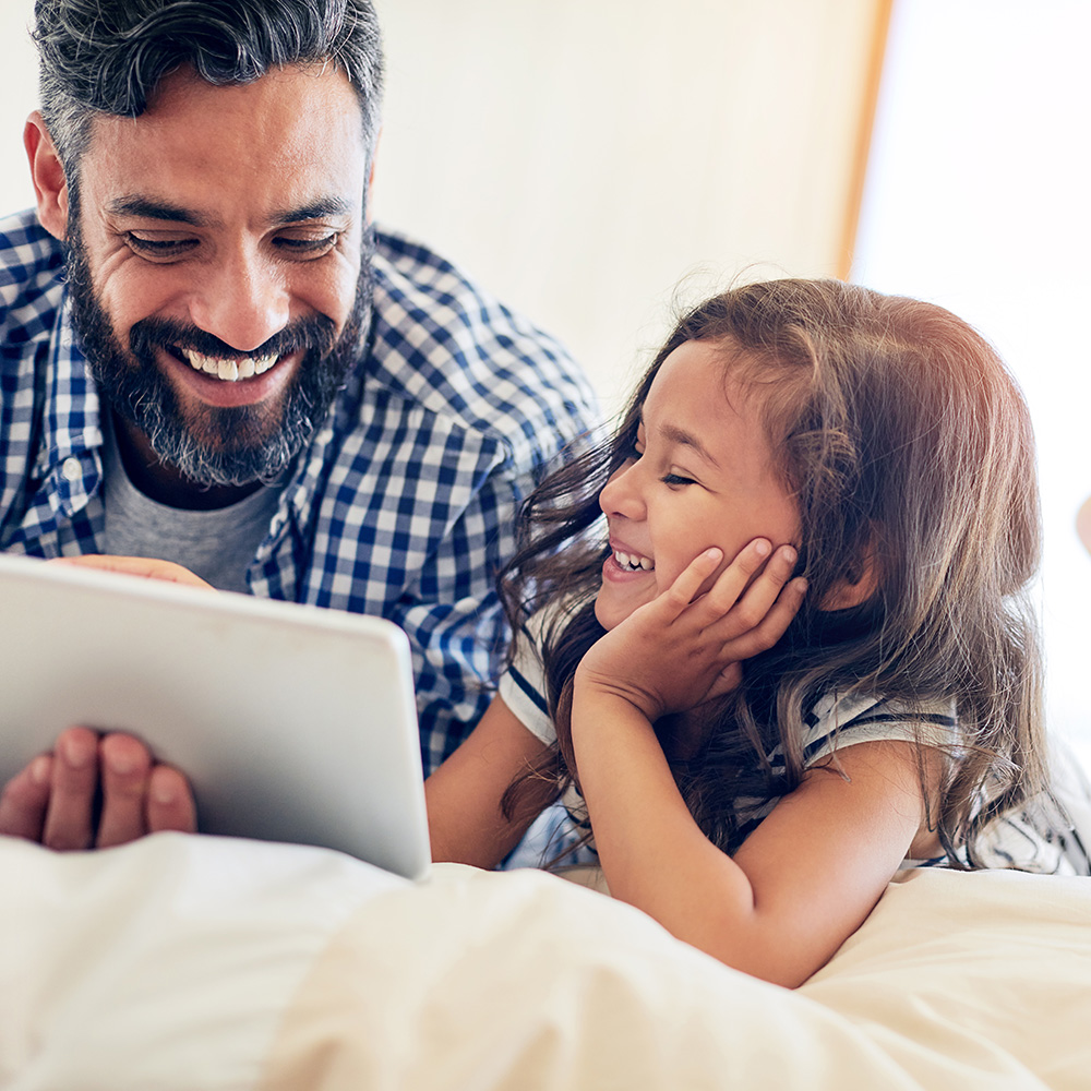 Father and daughter on an tablet device